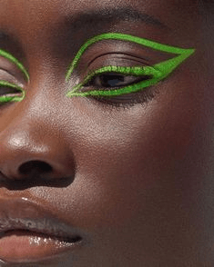 Black woman wearing bright green eyeliner