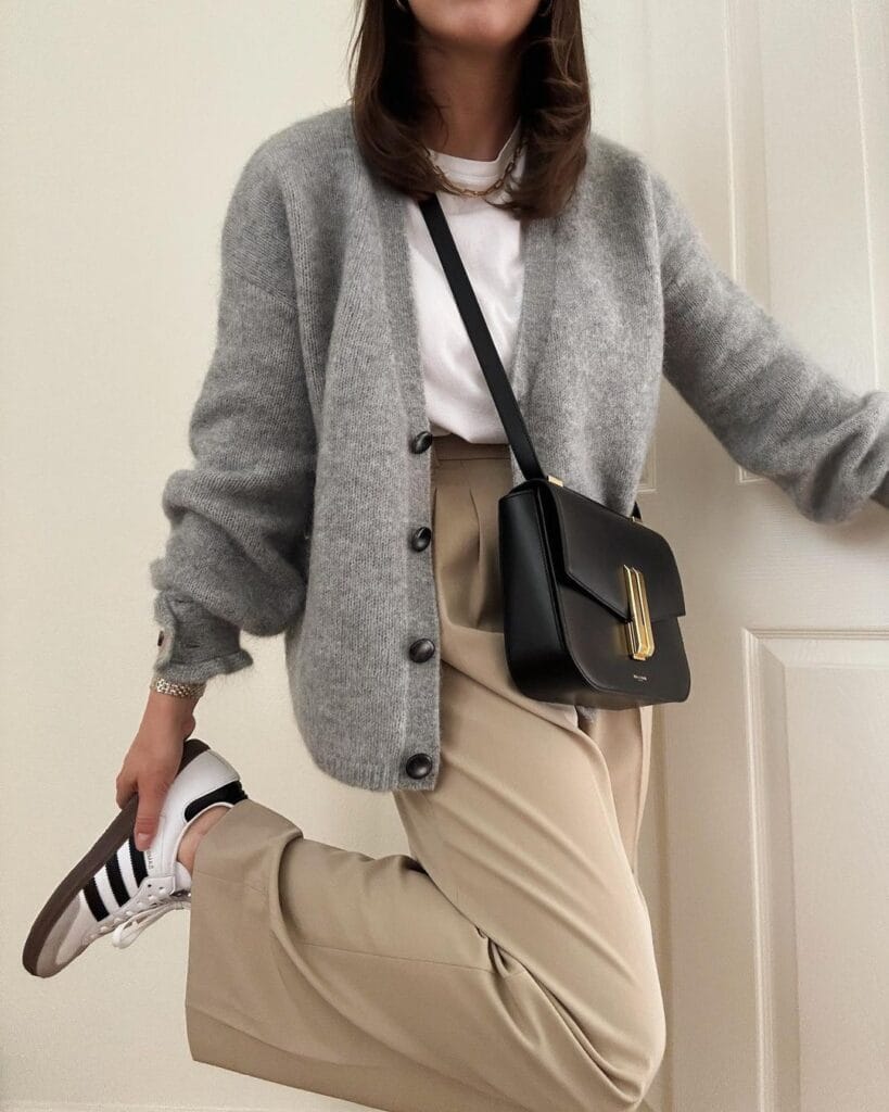 Woman wearing grey cardigan and Adidas Samba sneakers