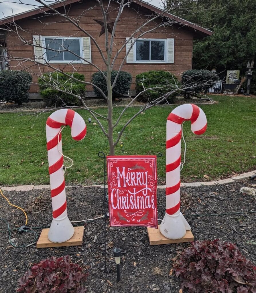 merry christmas outdoor sign with two candy canes for decoration